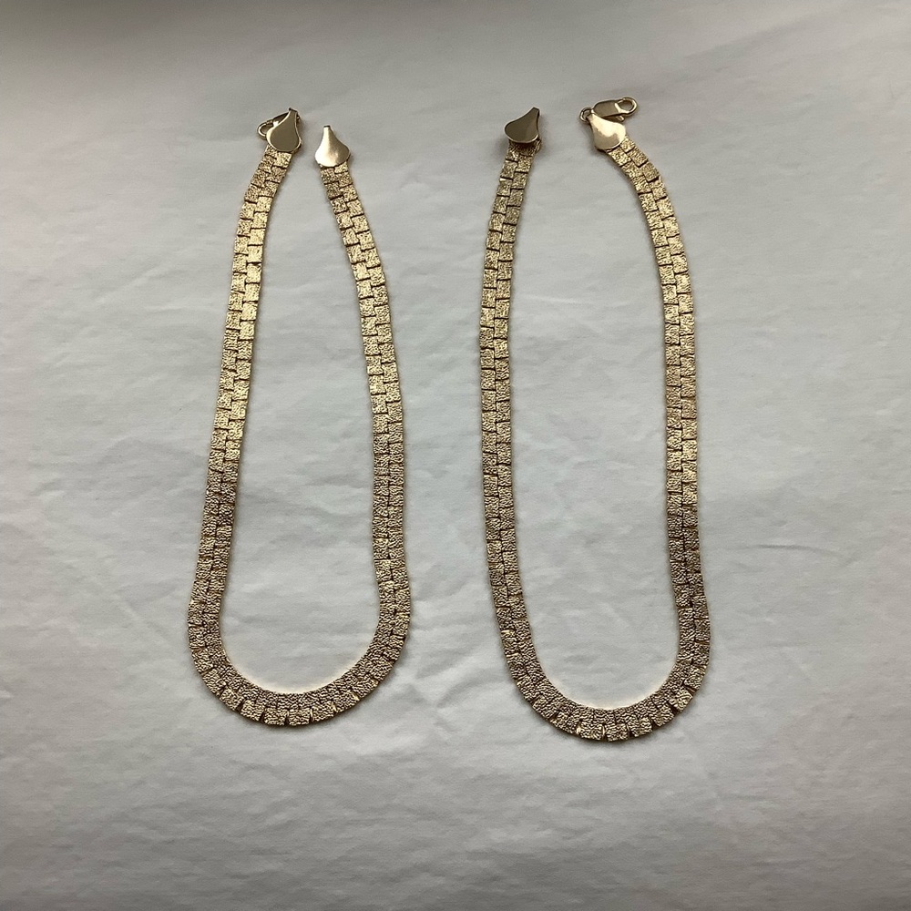 Pair of gold color metal necklaces